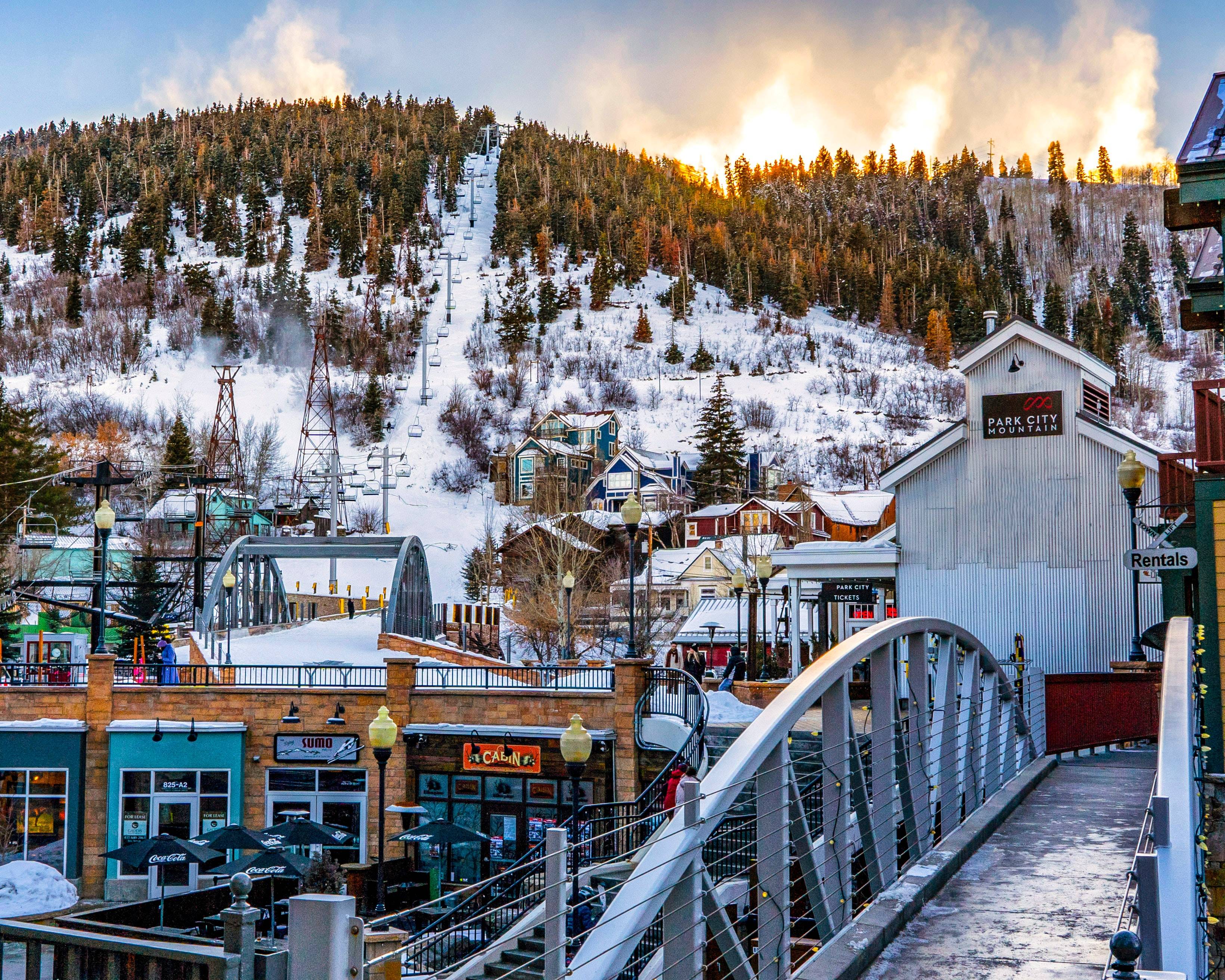 Park City Mountain Resort at dusk with snow covered roofs and ski runs